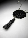 Pendant with a meteorite and lace
