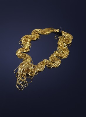 Ornament of thin metallic gold threads