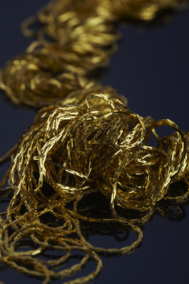 Ornament of thin metallic gold threads