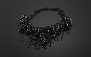 A short necklace made of metal chains and glass beads
