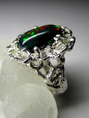 Ring with black harlequin opal