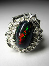 Ring with black harlequin opal
