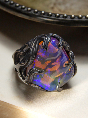Big neon opal ring in patinated silver
