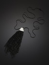 Decoration brush of black metal chains on a metal cord