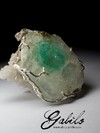 A large pendant with an emerald in beryl