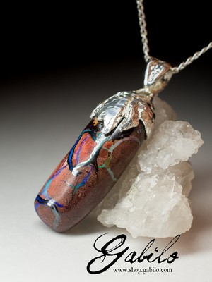 Silver pendant with boulder is shrouded in opal