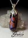 Silver pendant with boulder is shrouded in opal