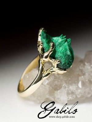 On order: a gold ring with plastique malachite