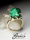 On order: a gold ring with plastique malachite